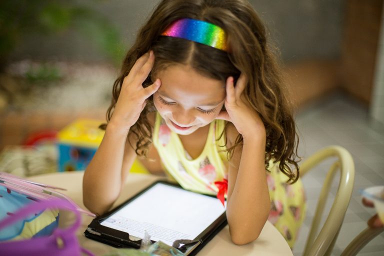 A young learner, learning on her educational software on a tablet